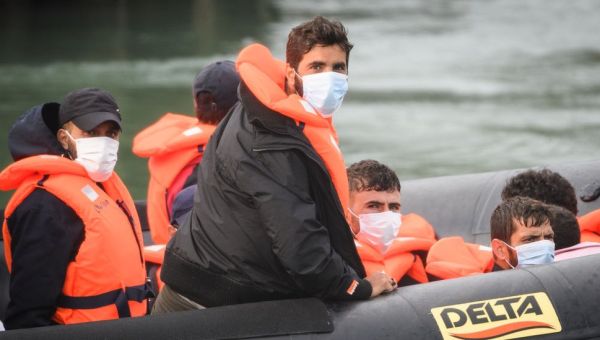 How many migrants cross the English Channel in small boats?