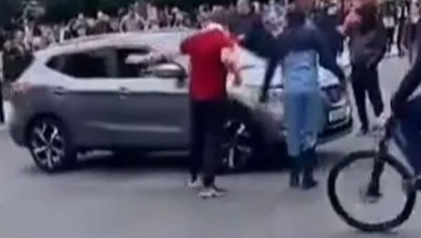 Moment rioters ask drivers if they’re ‘white & English’ before letting them pass