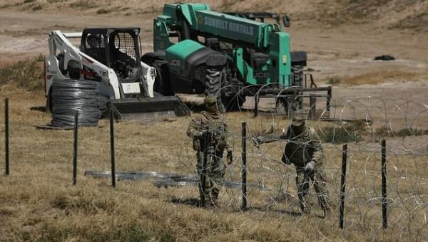 US to review migrants abroad, toughen penalties in revamp