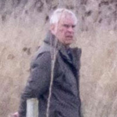 Andrew looks a world away from Royal life walking his dogs