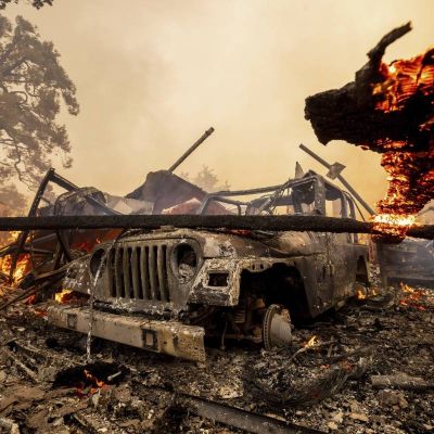 Firefighters advance on destructive blaze in California, aided by slower winds