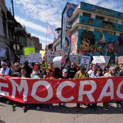 ‘Regime change begins at home’: thousand take part in ‘No Kings’ protests across US
