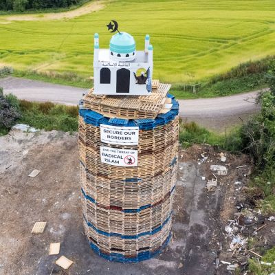 Bonfire with mosque replica placed on top set alight