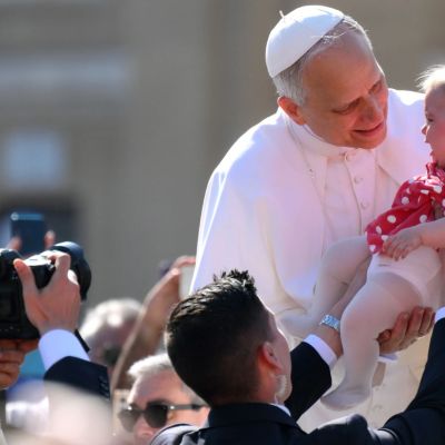 Pope Leo holds baby & waves to crowds as world leaders gather for inauguration