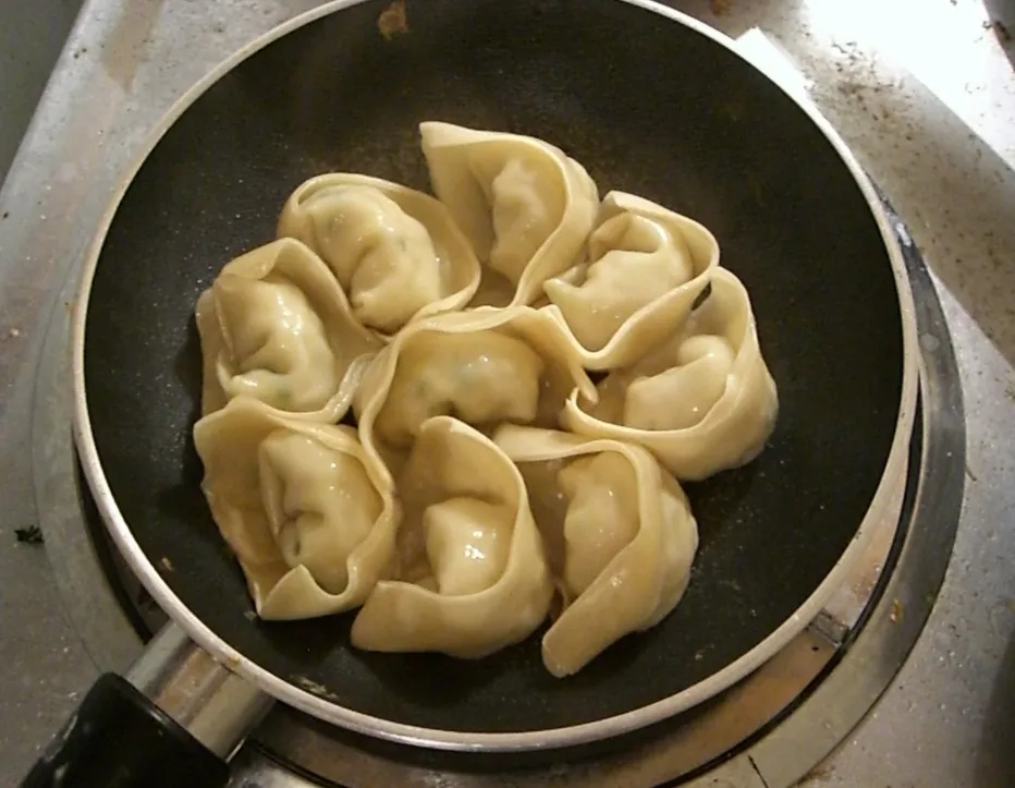 Gyoza, one of Japan's most popular chuka ryori dishes, being prepared in a traditional chukanabe