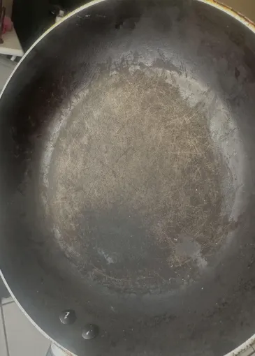 Damaged non-stick coating showing heat degradation and toxicity concerns