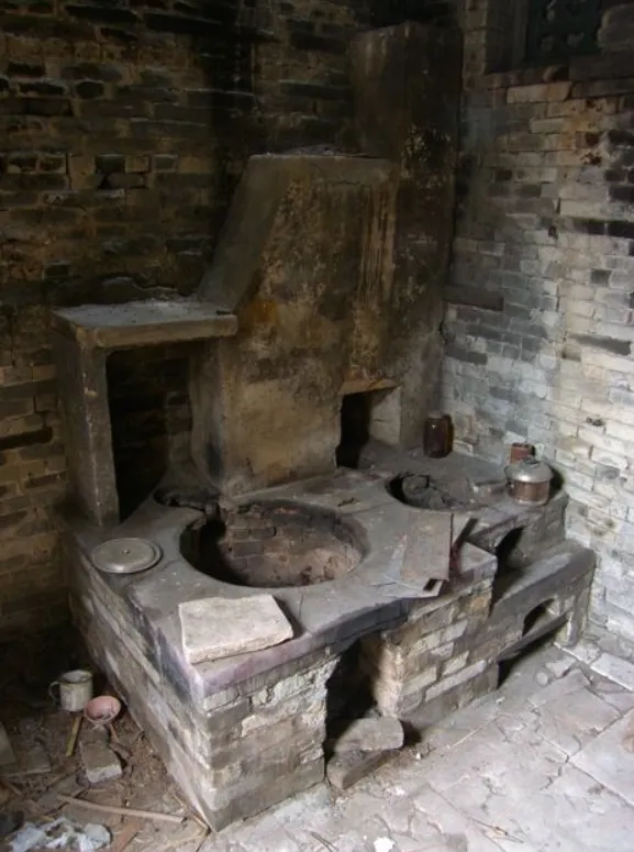 Traditional Chinese pit-style hearth showing how the wok's round bottom was designed to nestle directly into the stove opening