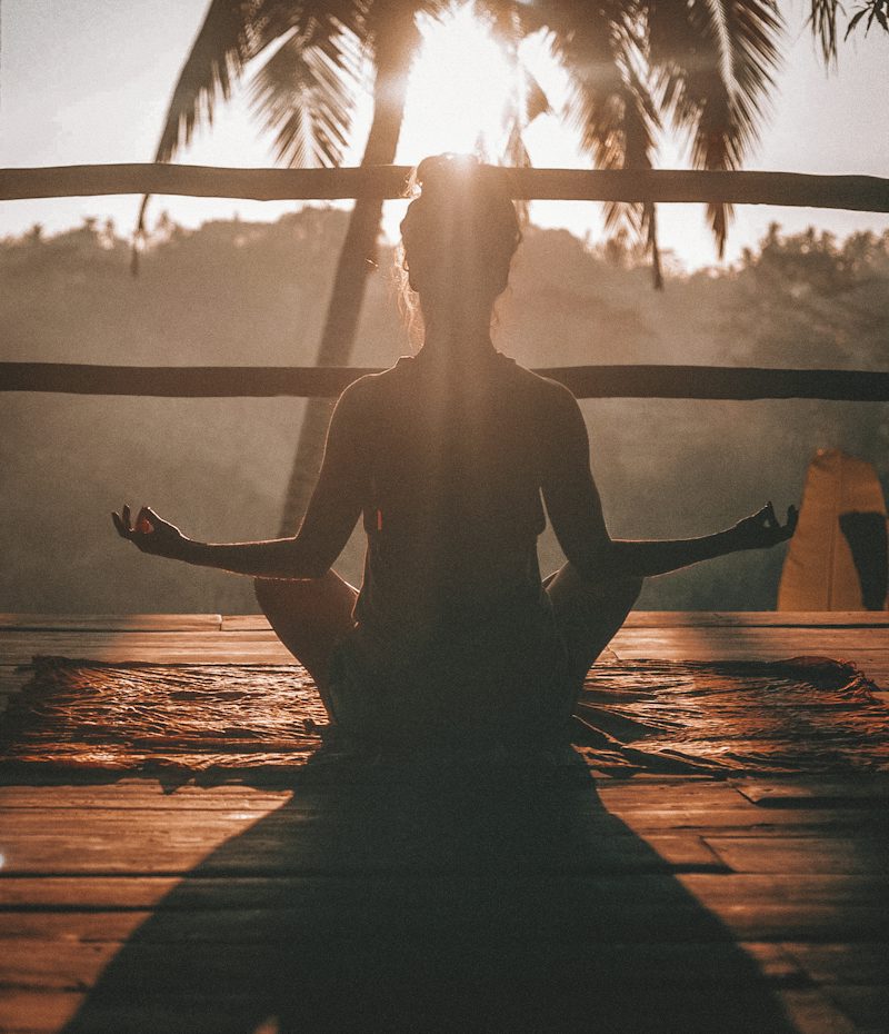 Teen practising calm breathing outdoors at sunrise