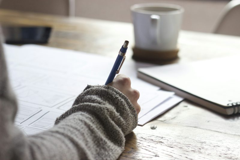 Student writing focused study notes