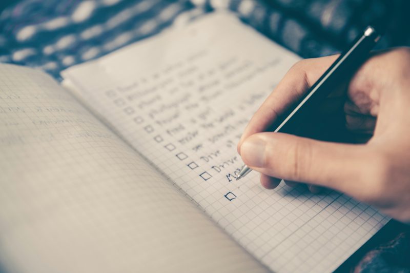 Daily planner with checked habits on a desk