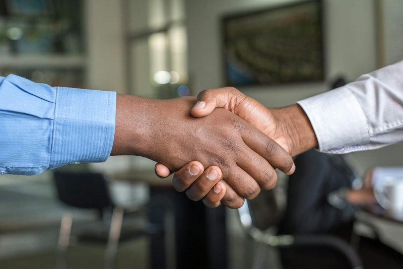 Two people shaking hands after a hard conversation