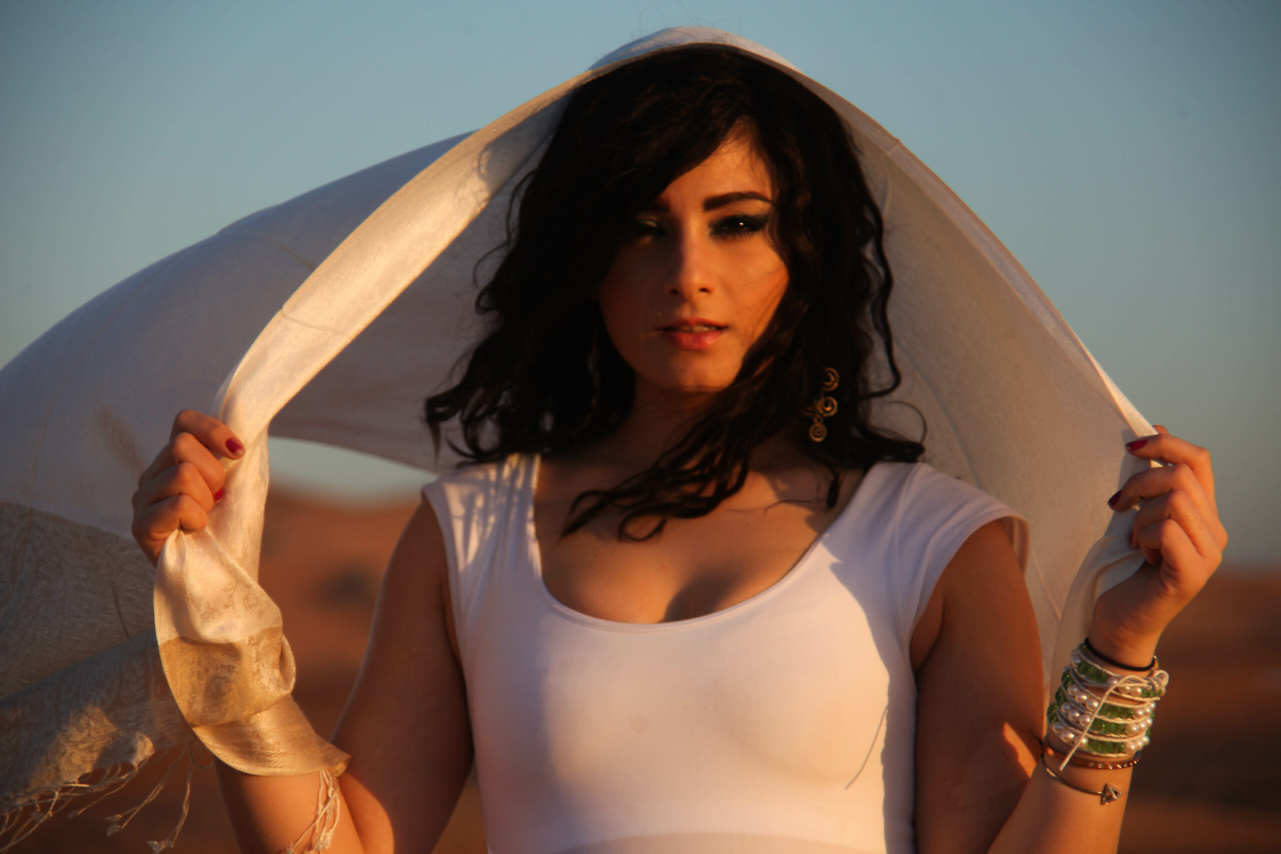 Mariam Ganni wearing a white scarf in Hattas Desert