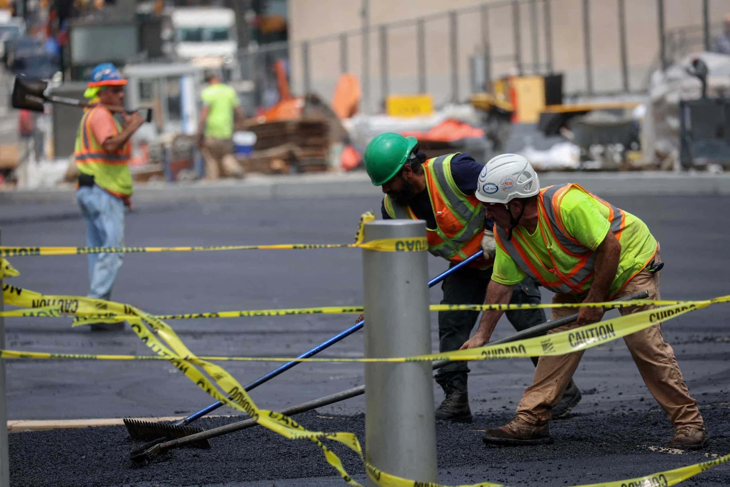 Workers-spread-hot-asphalt-on-a-road-after-New-York-City-issued-an-excessive-heat-warning-scaled-1
