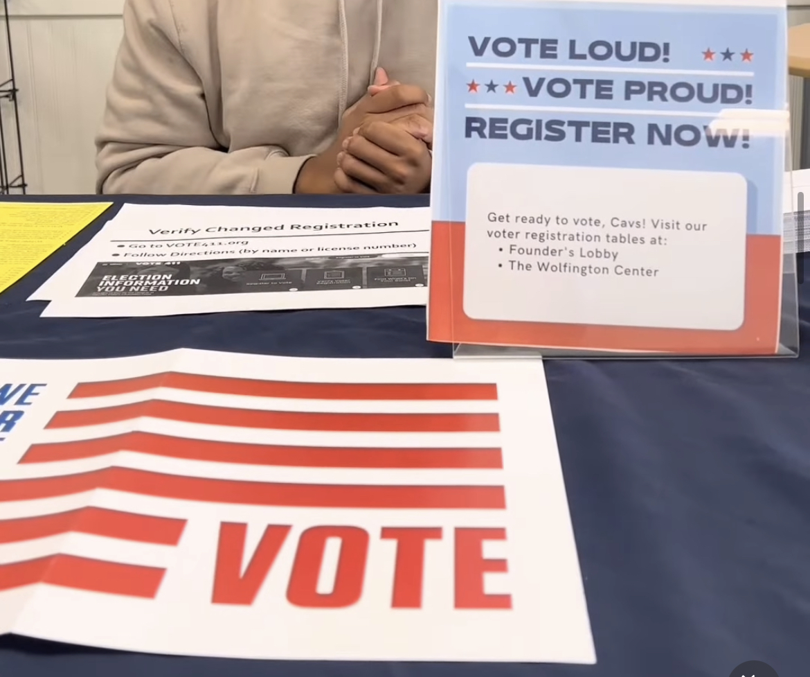 Voting in instructions onvoting registration table presented by the Wolfington Center