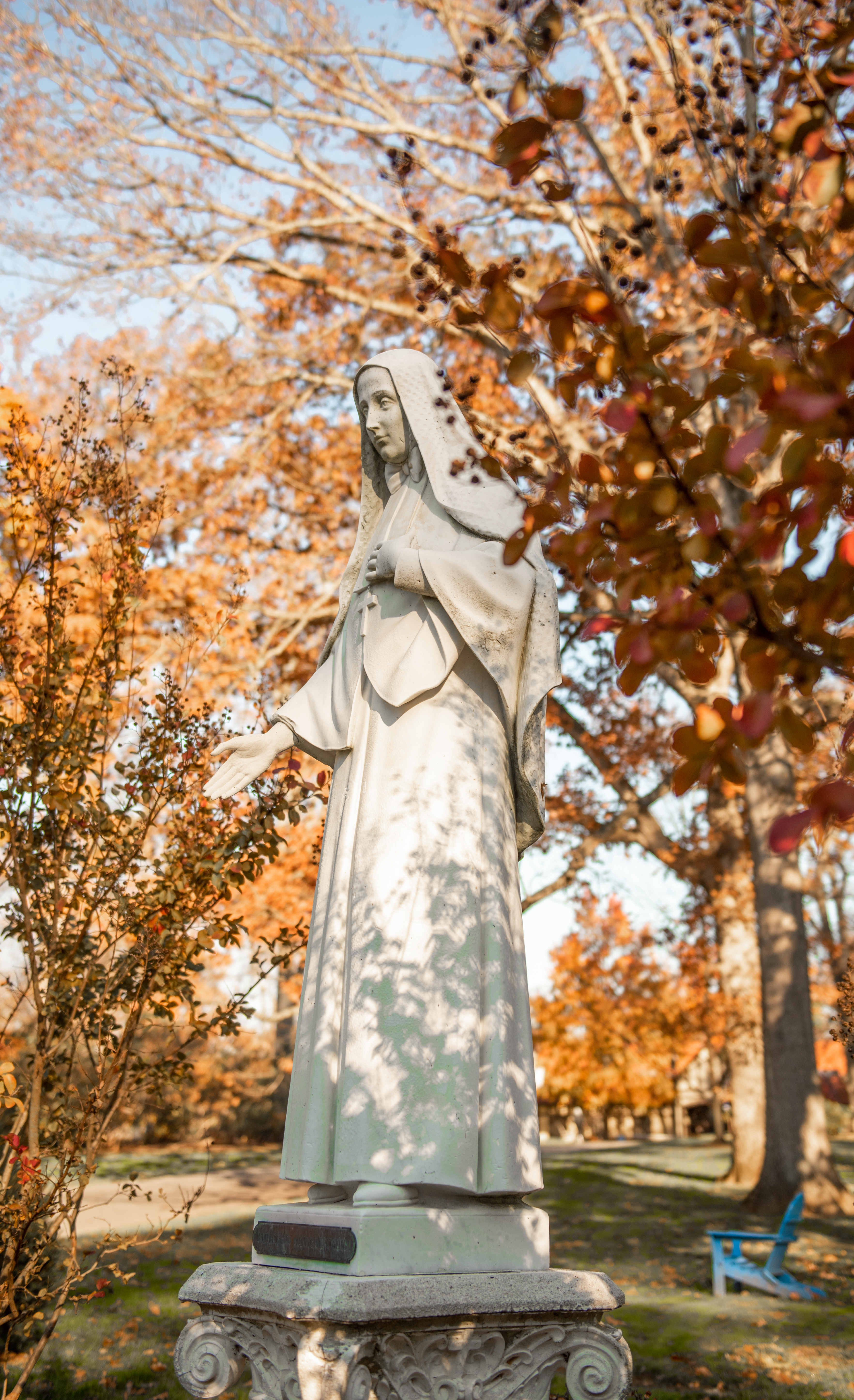 Mother Cabrini statue with fall colored trees