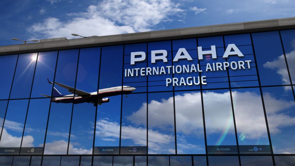 Airplane landing at Praha, Prague mirrored in terminal