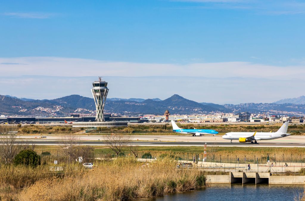 Landing strip at Barcelona airport with planes on the runway