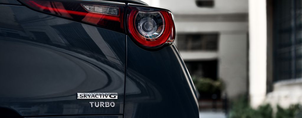 Model Features of the All-New 2024 Mazda CX-30 at Lancaster Mazda | Rear taillights of a 2024 Mazda CX-30 with the SkyactivG Turbo badging
