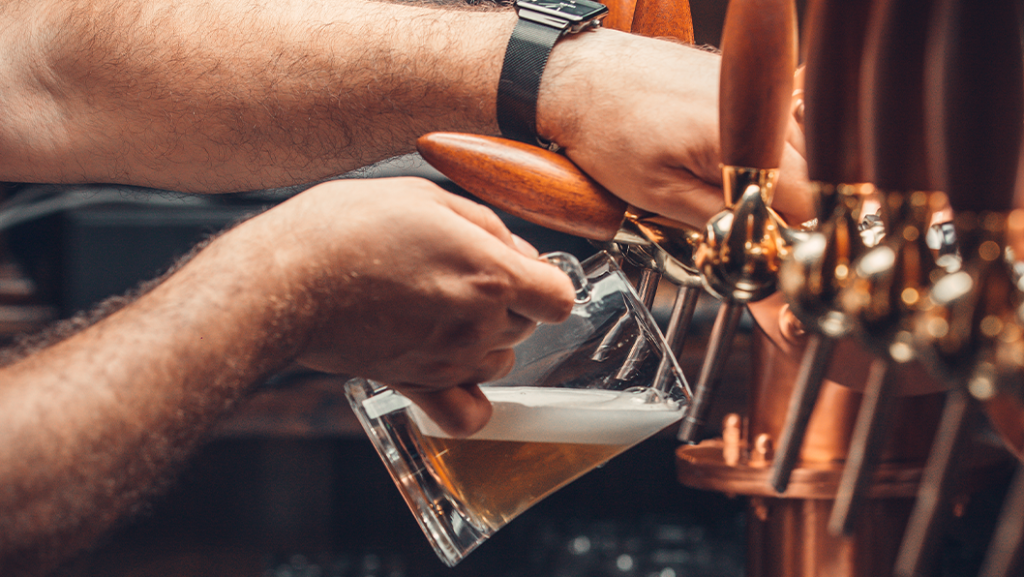 Toyota Dealer Near St Marys | Person pouring beer into glass on tap