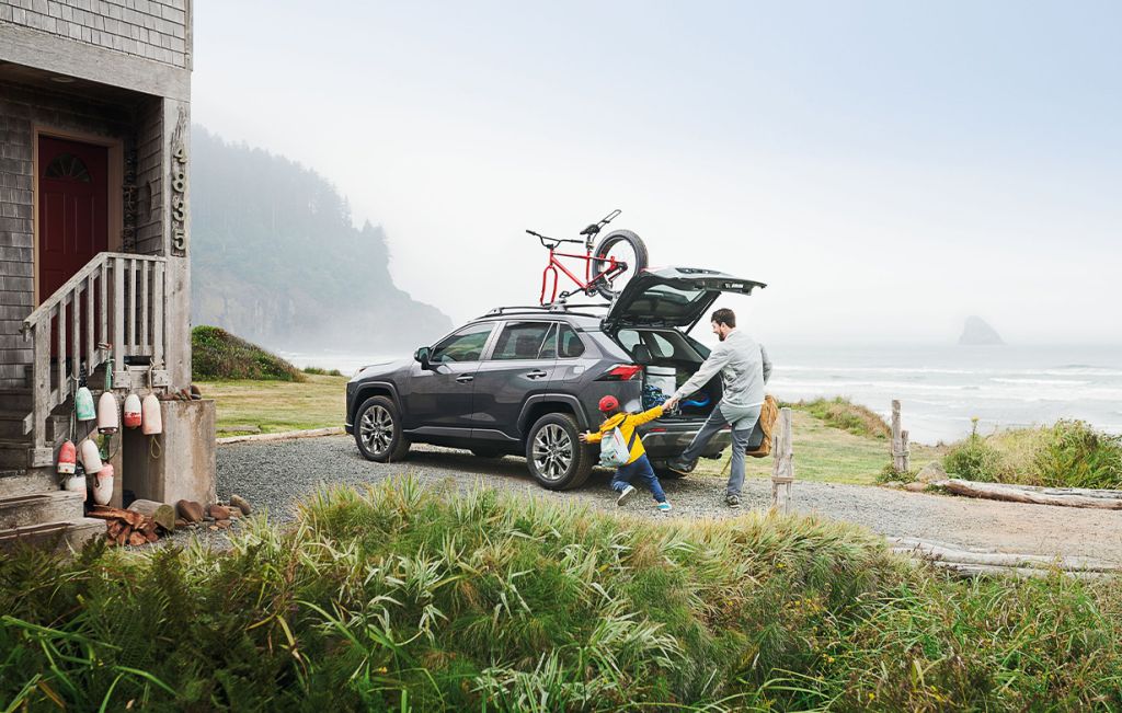 2025 Toyota RAV4 vs 2025 Subaru Forester comparison | Bobby Rahal Toyota | Father packing up his RAV4 with his son while the trunk is open