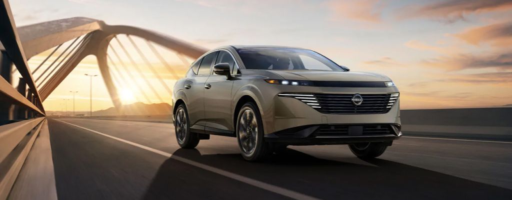 2025 Nissan Sentra at Delaney Nissan of Greensburg | front profile of a 2025 Nissan Murano driving down a bridge during the day