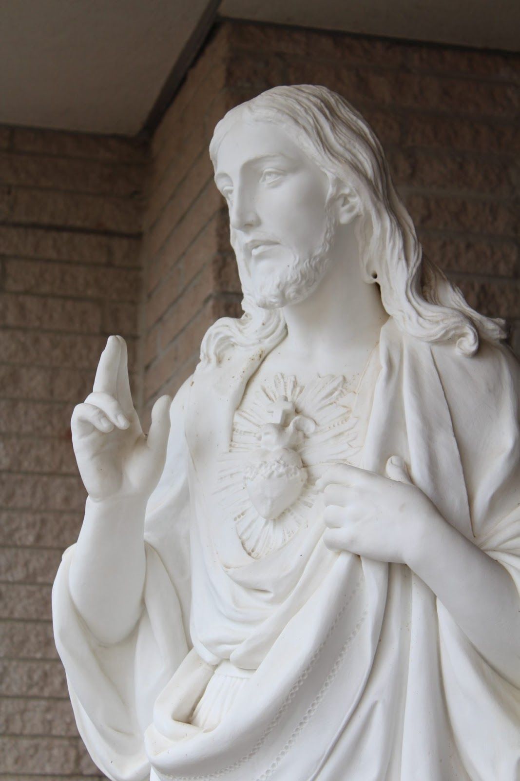 A statue of The Sacred Heart of Jesus outside St. Eleanor Church, greeting and blessing all who enter. Photo by Jana Cainglet.