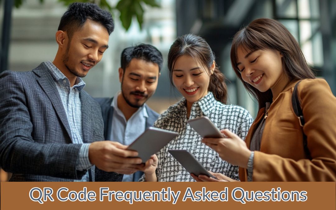 Four people are standing together, looking at electronic tablets and smiling. Text in the image reads, "QR Code Frequently Asked Questions.