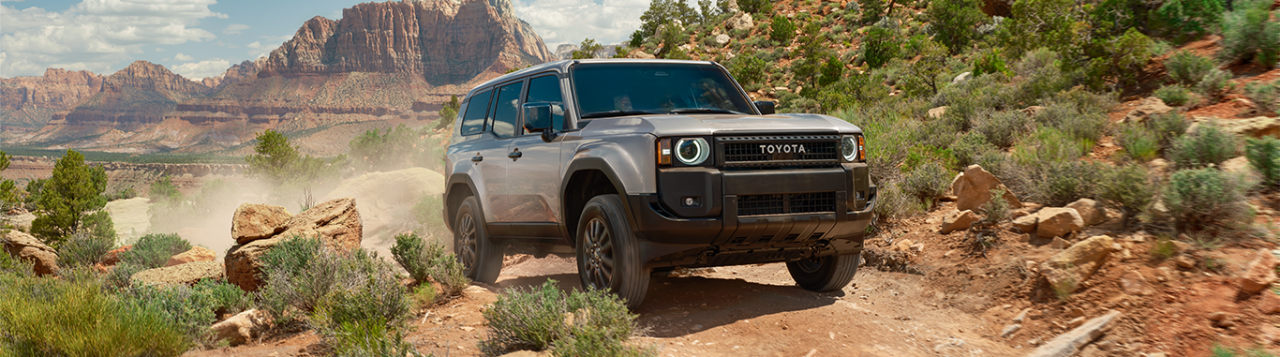 2024 Toyota Land Cruiser at Lancaster Toyota in East Petersburg, PA | Front profile of a grey color 2024 Toyota Land Cruiser driving up a dirt road