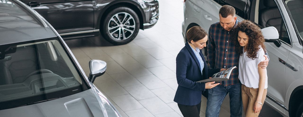 Why drivers should consider an extended warranty on their Hyundai at Delaney Hyundai of Dubois | Sales person at the dealership showing a couple some of the car options for extended warranties