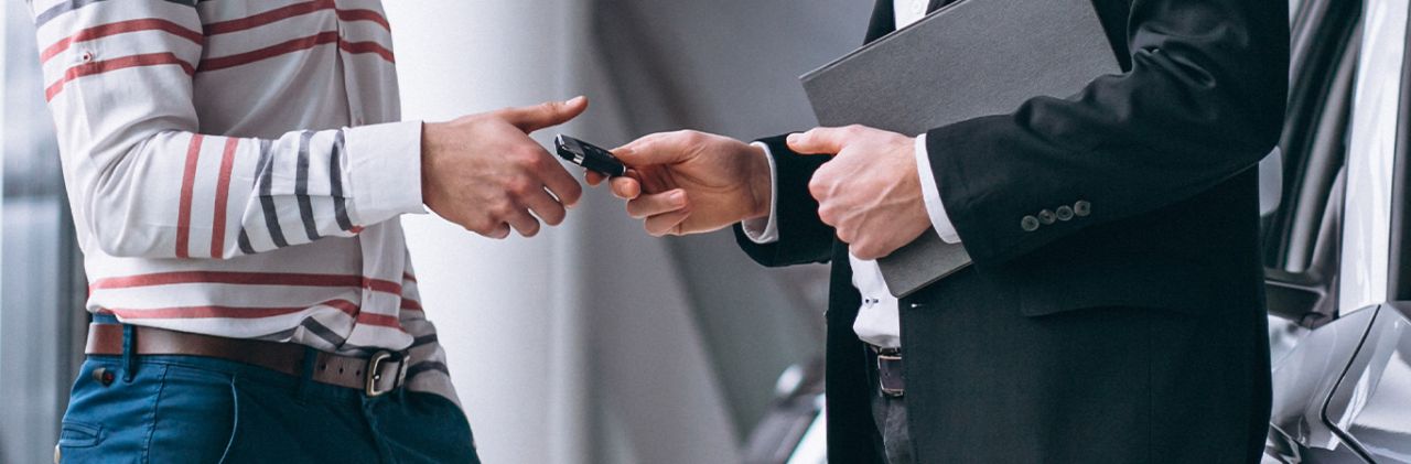 When to Trade In Your Car | Delaney Toyota of DuBois in DuBois, PA | Customer handing over car keys to dealership sales assoicate