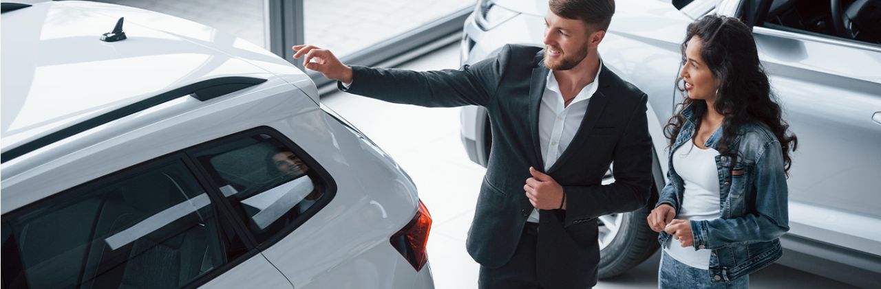 When to Trade In Your Car | Stetler DCJR in York, PA | Sales person showing customer the different car options in the dealership