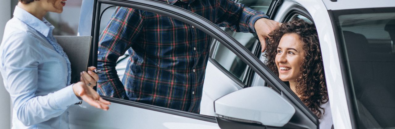 When to Trade In Your Car | Stetler DCJR in York, PA | Woman sitting in her new car all happy while talking to sales person