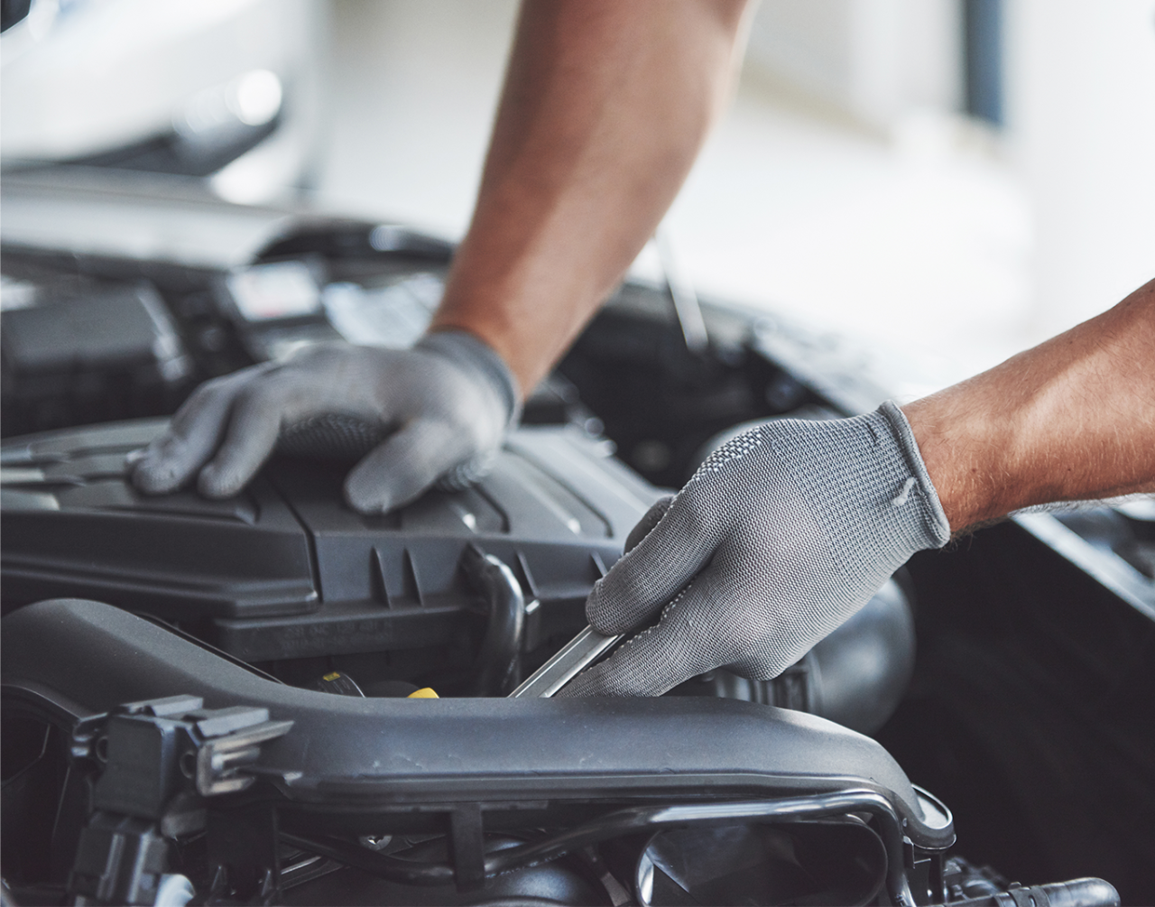 Basic Car Maintenance and Servicing Checklist | Palmiero Toyota | Mechanic with grey gloves using a wrench in the engine bay