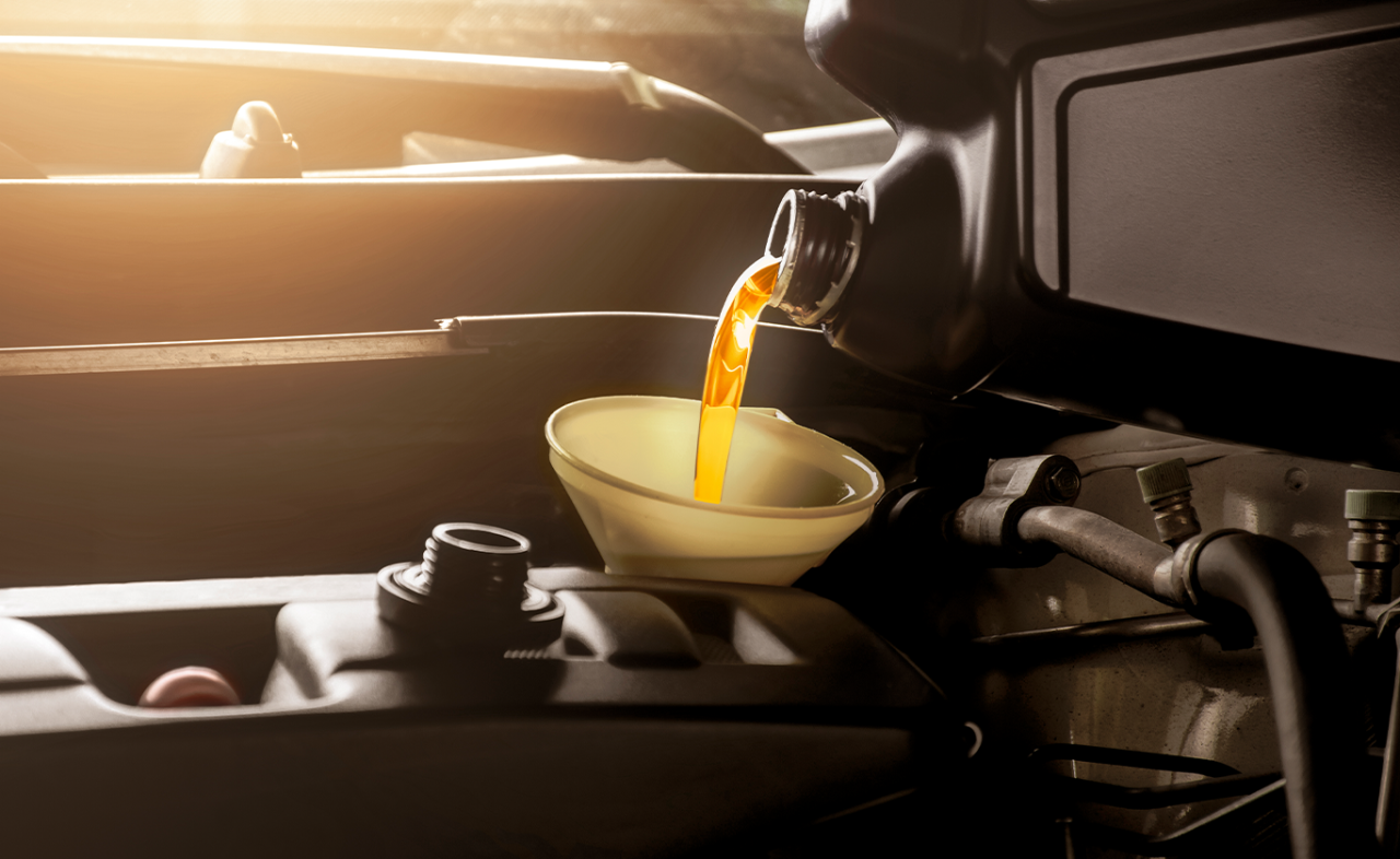 Basic Car Maintenance and Servicing Checklist | Palmiero Toyota | New yellow engine oil being poured into car engine 
