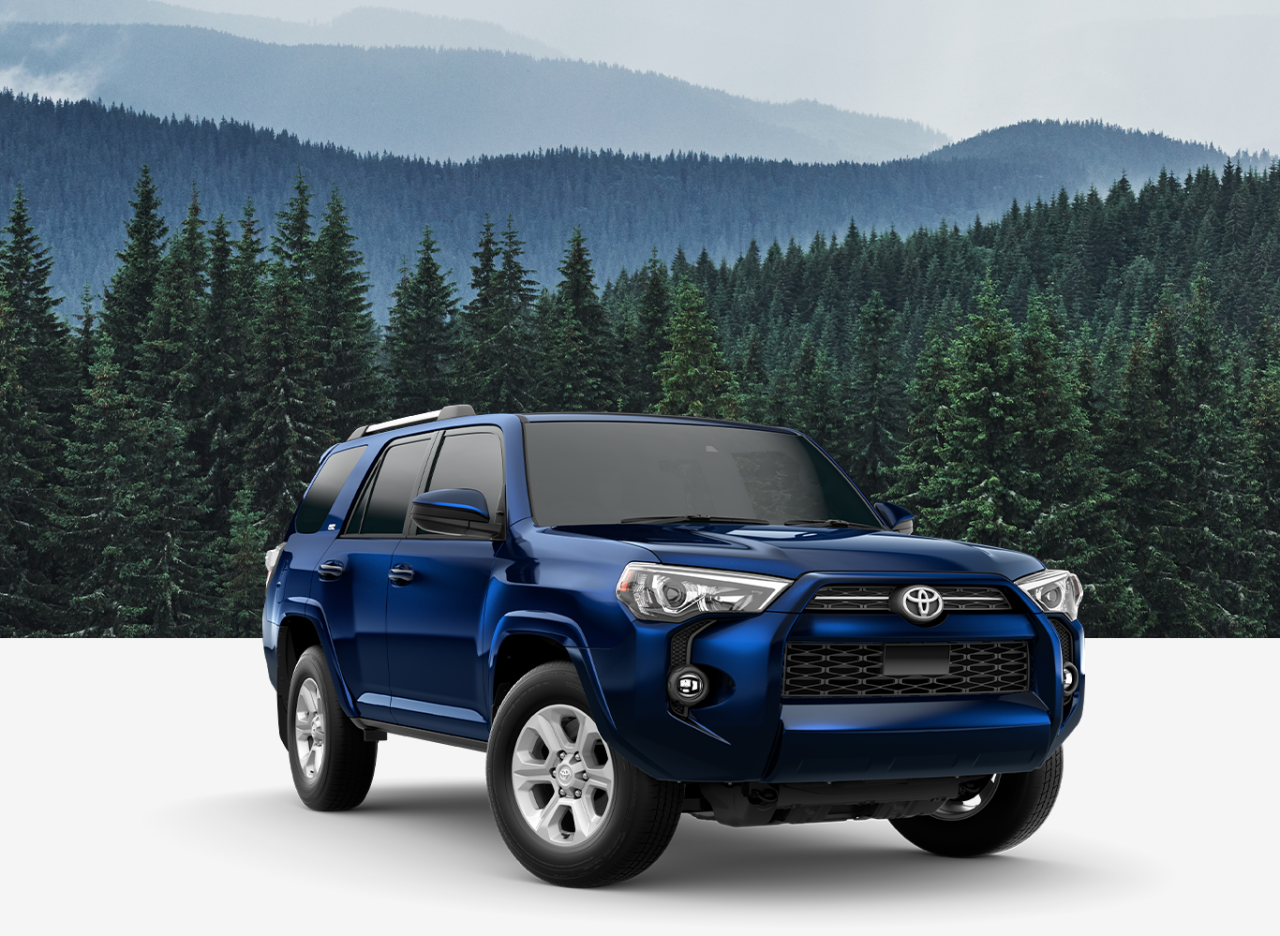 Basic Car Maintenance and Servicing Checklist | Palmiero Toyota | Front view of a blue Toyota 4runner with a background of a forrest and blue mountains 