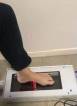 A laser scanner taking a scanner of a foot.