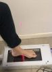 A laser scanner taking a scanner of a foot.