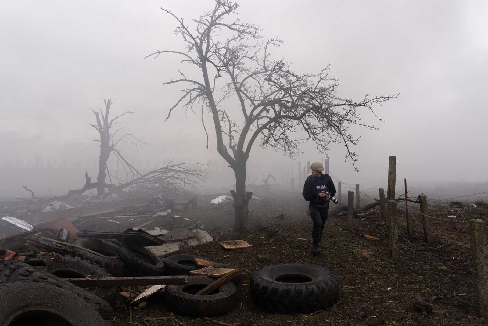 Photographer Evgeniy Maloletka picks his way through the aftermath of a Russian attack in Mariupol, Ukraine, Feb. 24, 2022. (AP Photo/Mstyslav Chernov.) 