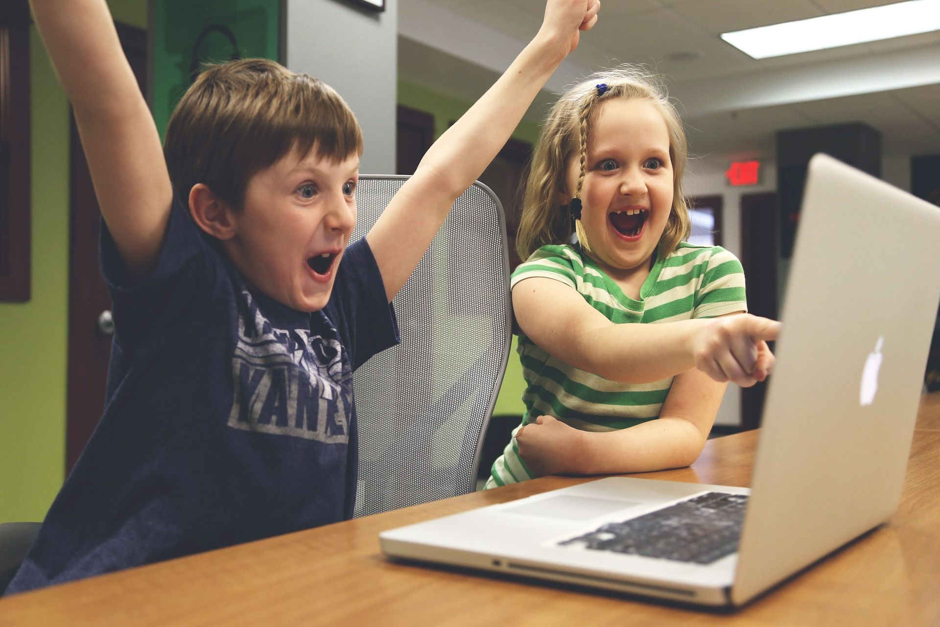 Here is an image of two kids watching a TV show on their Computer. 
Photo credits by Pixabay the link of the photo is bleow. 
https://pixabay.com/en/children-win-success-video-game-593313/