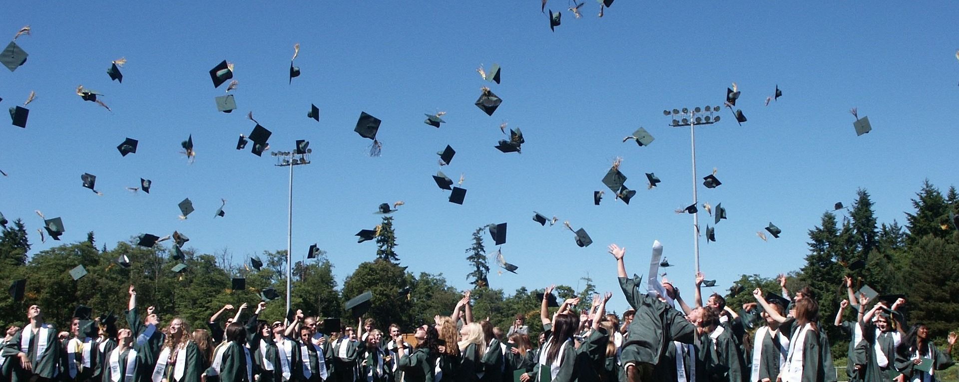Newly graduated students throwing the their caps. Photo by greymatters via Pixabay
