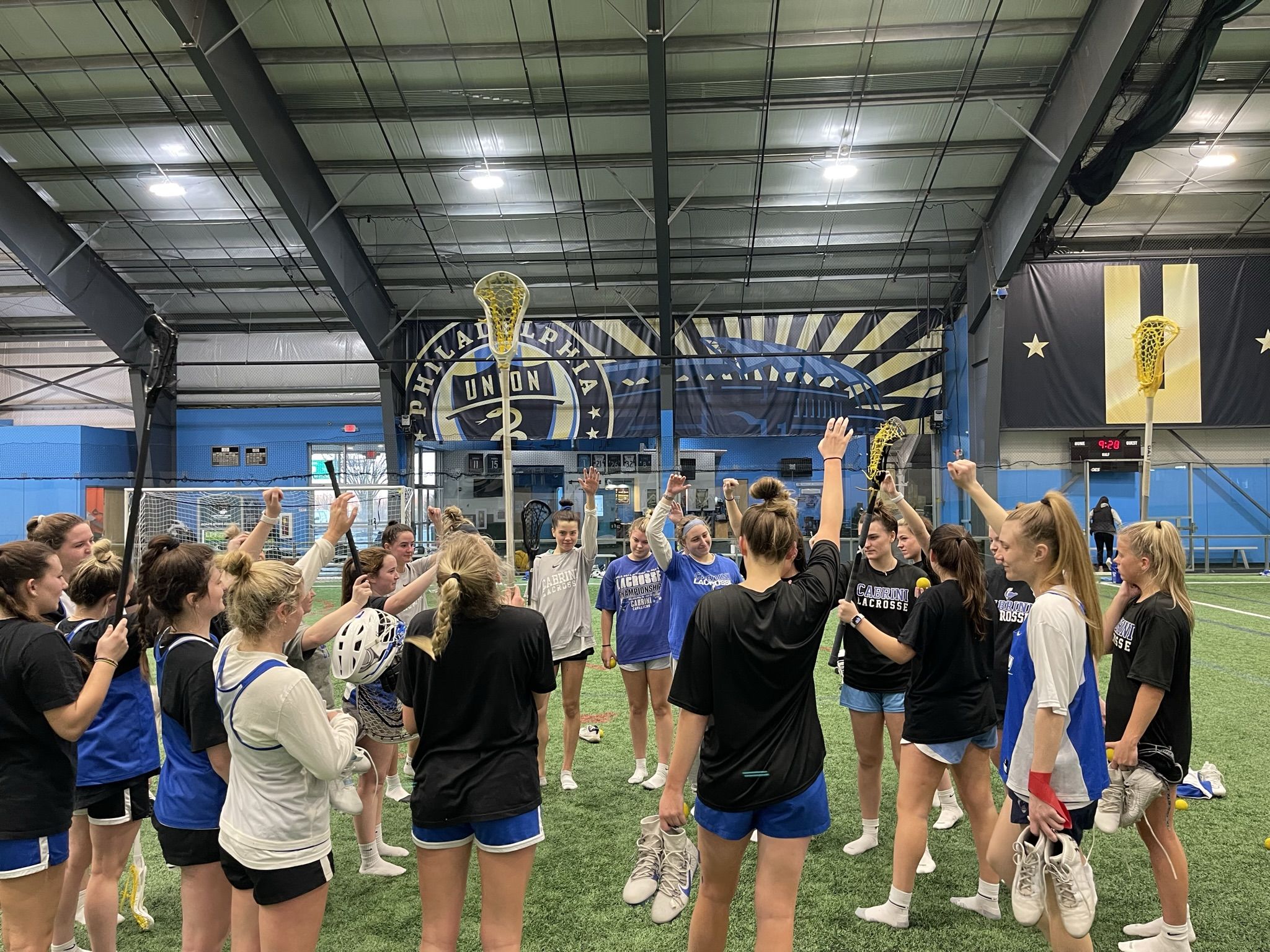 Cabrini women's lacrosse team huddles up at the end of practice. Photo by Julie Cross.