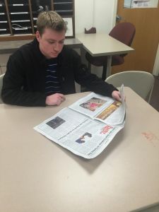 Assistant sports editor Kevin Moylett reading and studying up on previous columns of the Philly Sports Box