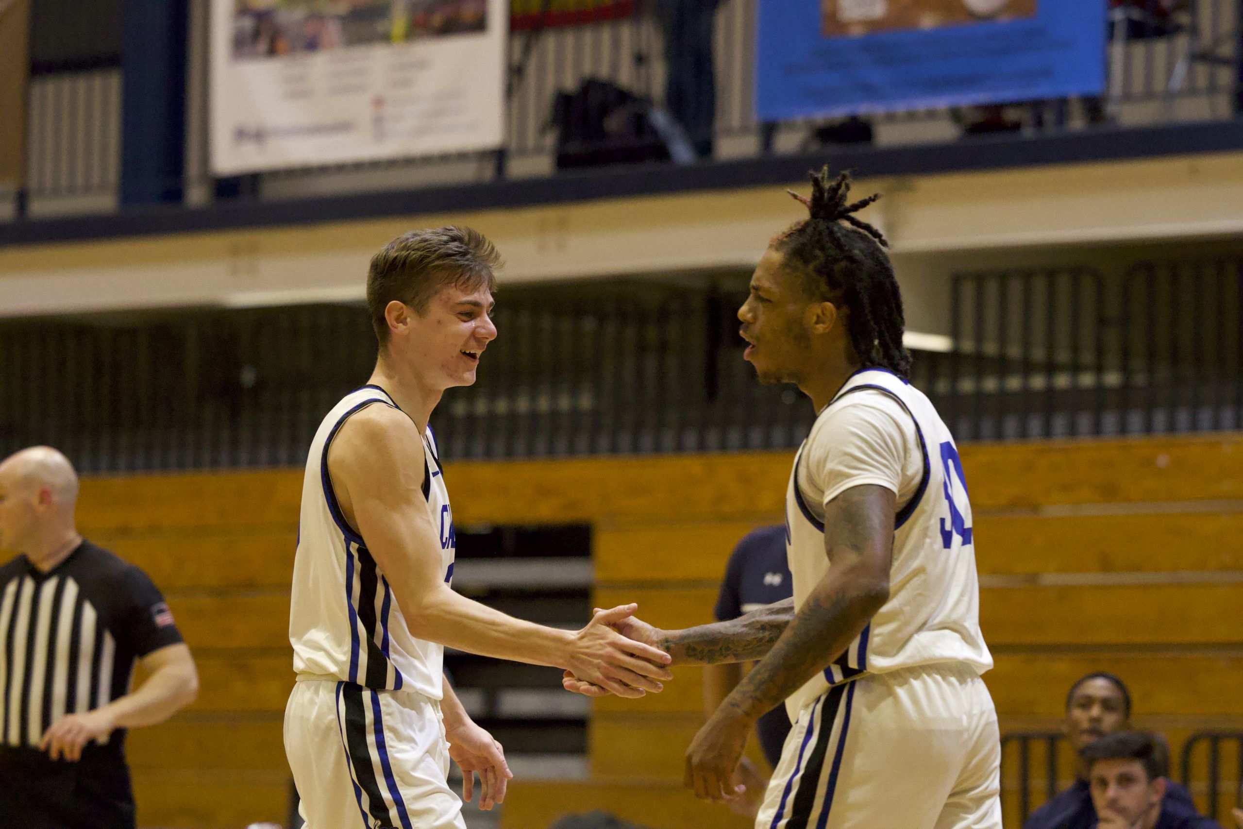 Cabrini players high five after taking lead. Photo by Thomas Ryan.