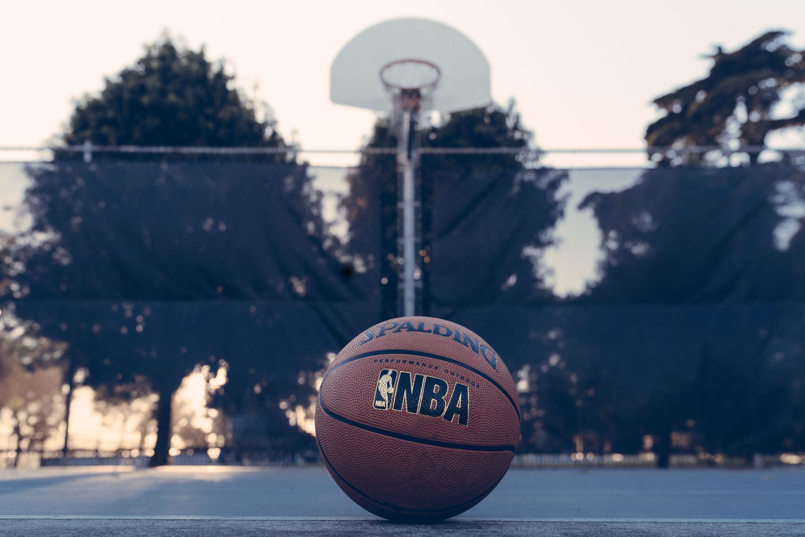 Basketball on a court. Photo by Edgar Chaparro from Unsplash.