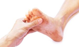 A hand holding a dirty foot