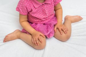 A young child sitting in W-position which is bad for the hips