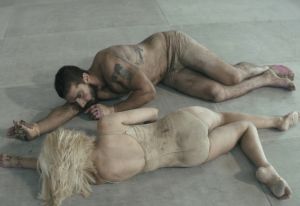 Creative Commons Sia’s new “Elastic Heart “ video features a white backdrop filled with a cage, a little girl in a platinum wig, and a shirtless Shia LaBeouf.. 