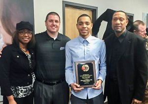  Senior guard Howard Blake III (middle right) accepts Sam Cozen award with mother Sonya Blake (far left) and father Howard Blake II (far right) and Head Coach Tim McDonald (middle left).