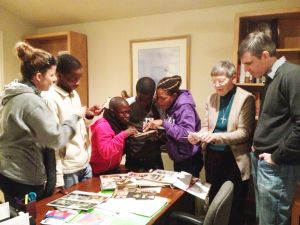 Students looking through photos with Sr. Grace Waters, MSC at her home in Havertown, PA.