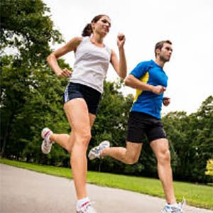 A man and woman going for a run in a park
